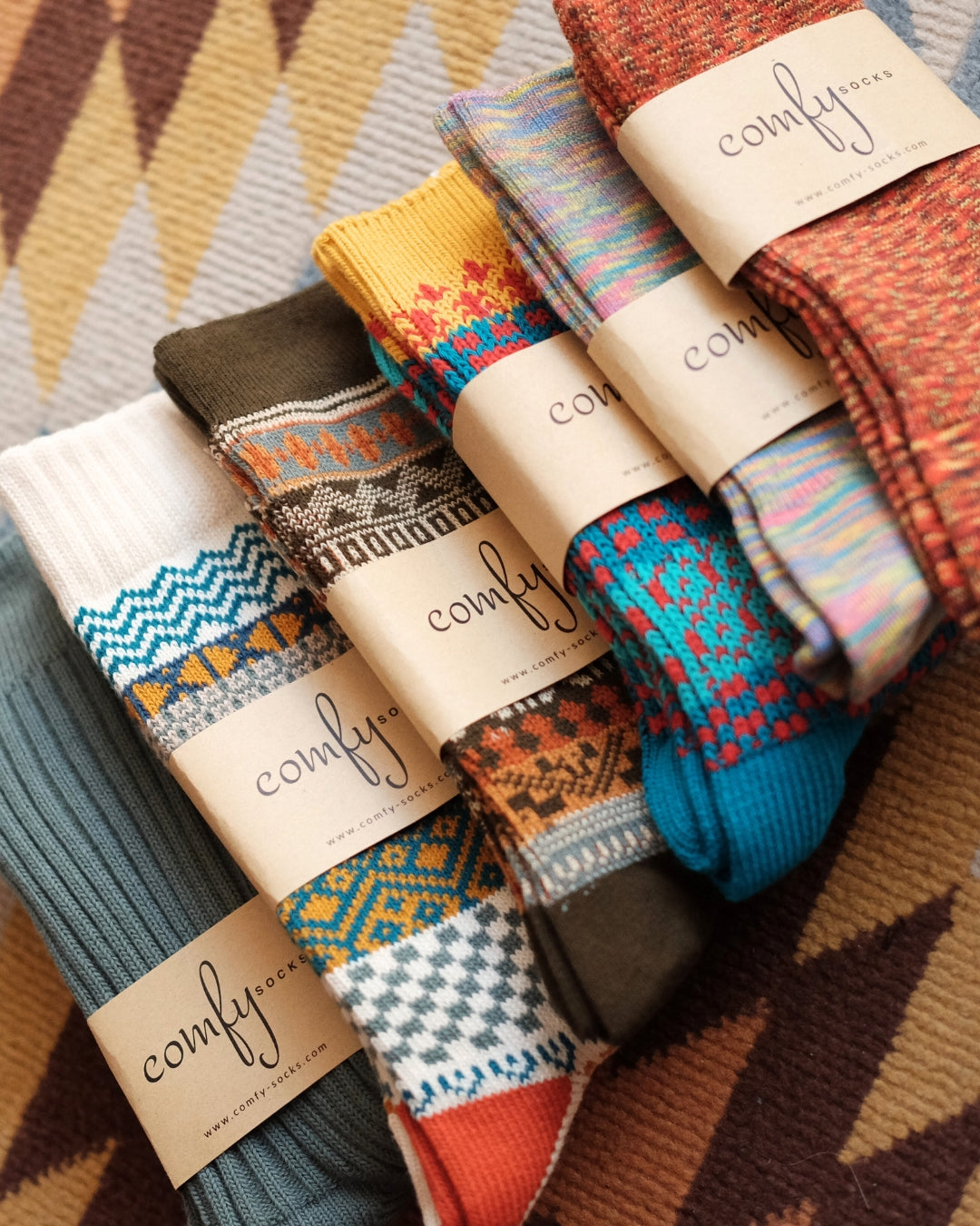 Gift-ready Christmas sock collection with funky patterns and cozy knit styles displayed togethe