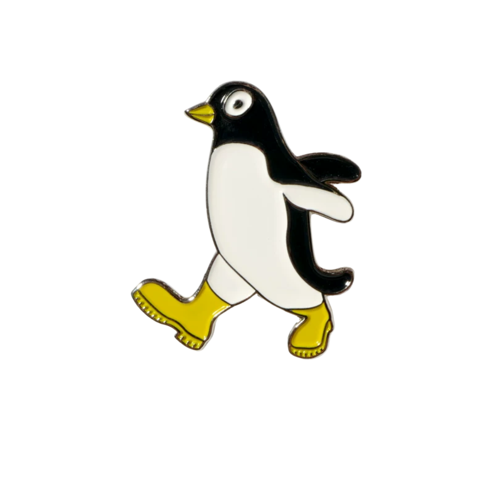 Penguin enamel pin with yellow boots on white background