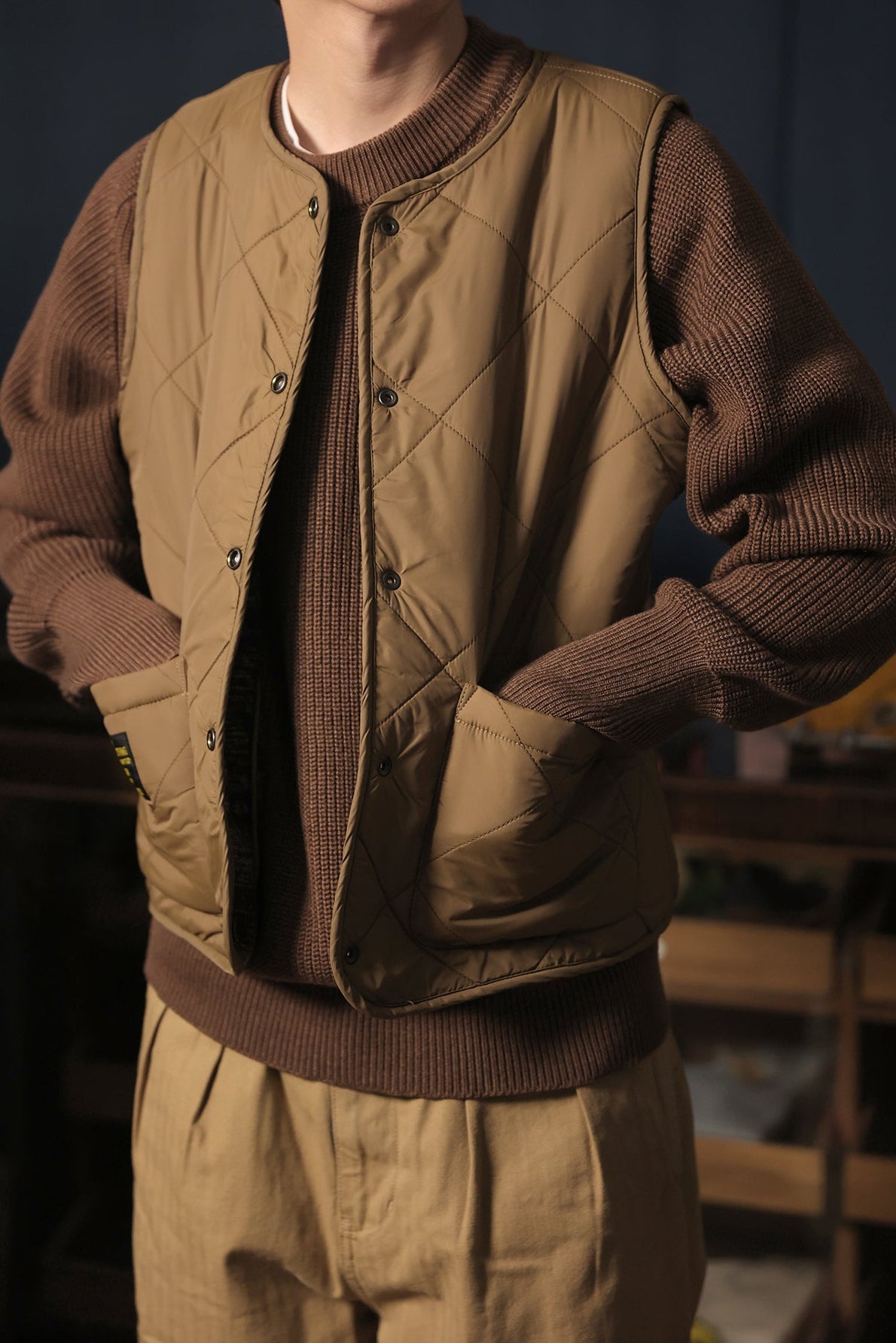 Vintage reversible vest in brown with tribal knit pattern front and quilted beige reverse.