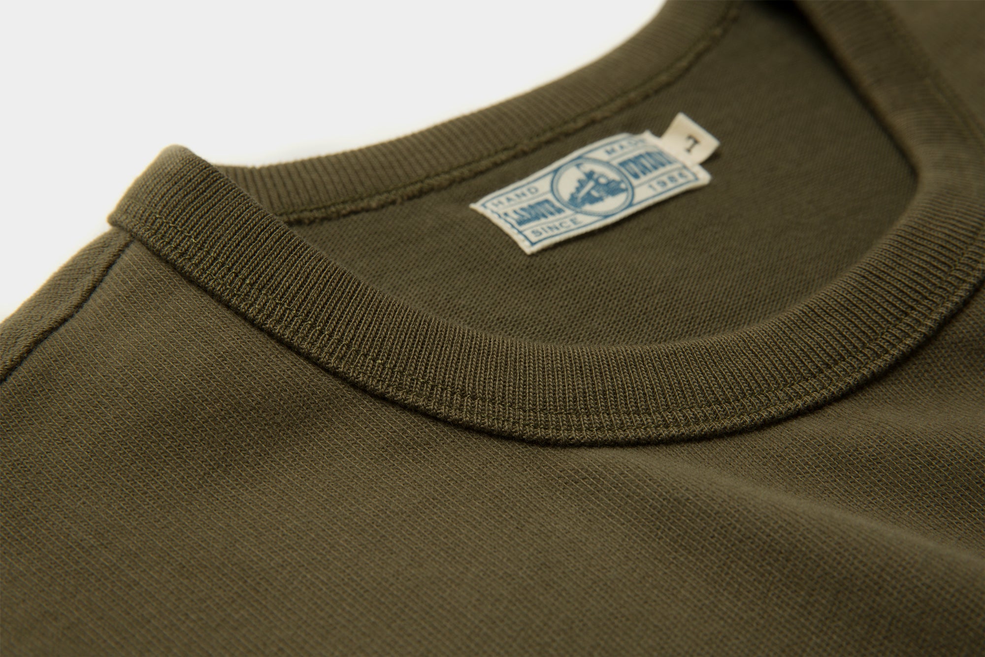 American Cotton crewneck tee in Olive Green flat lay on white background