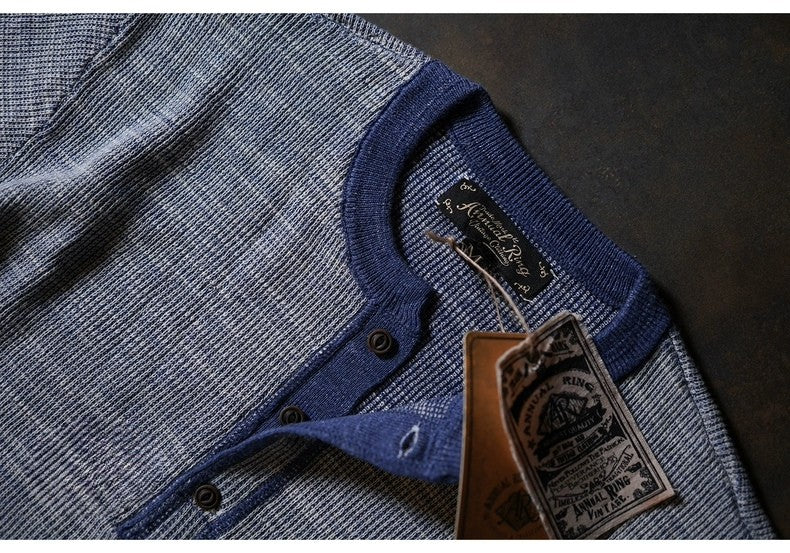 Detail shot of heavyweight indigo waffle knit cotton henley fabric texture