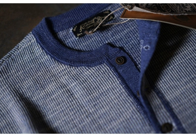 Close-up of indigo waffle knit henley showing textured cotton fabric and button placket