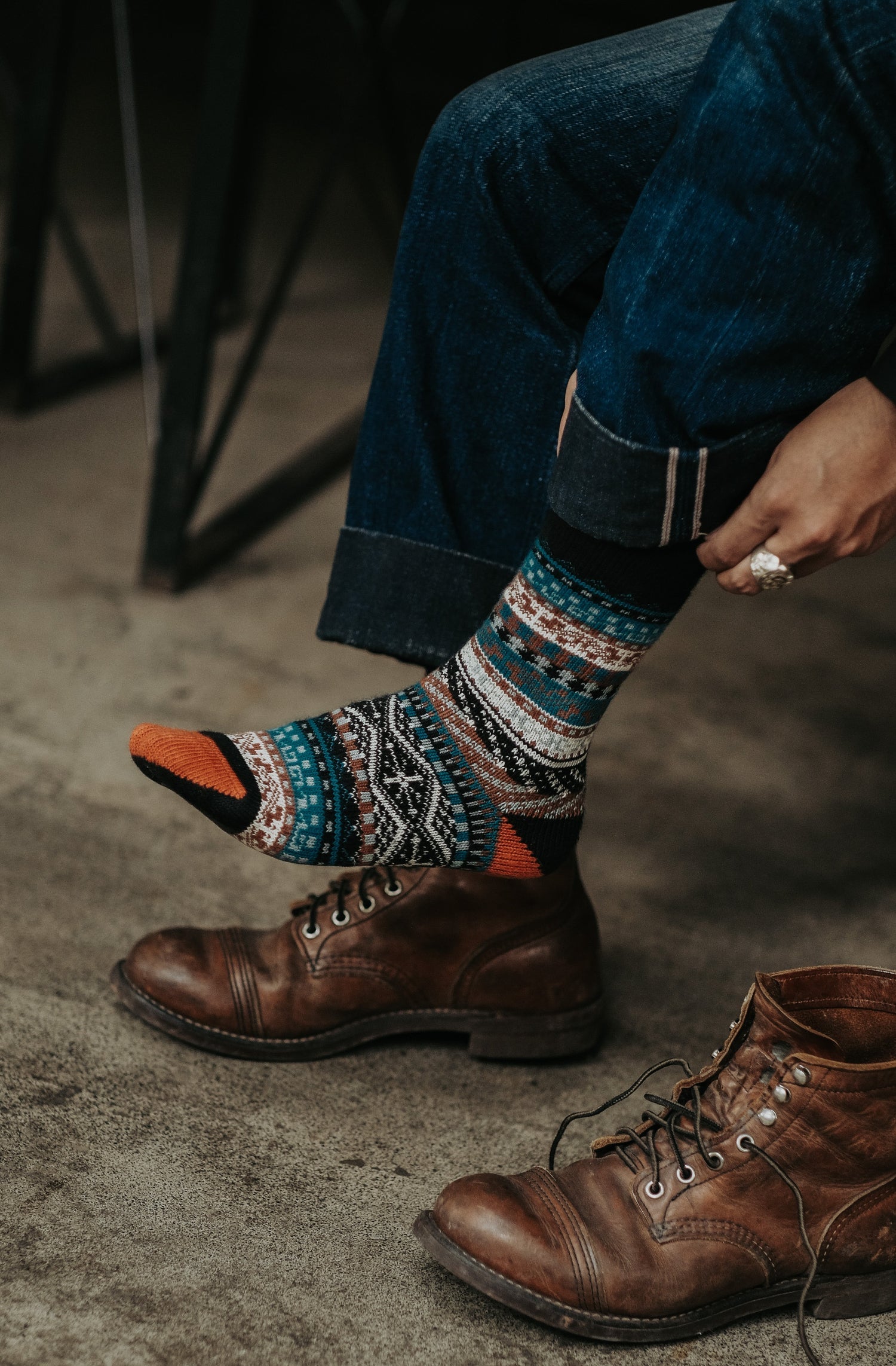 Men's bold tribal pattern socks in orange red and blue worn with tan leather work boots — ComfySocks