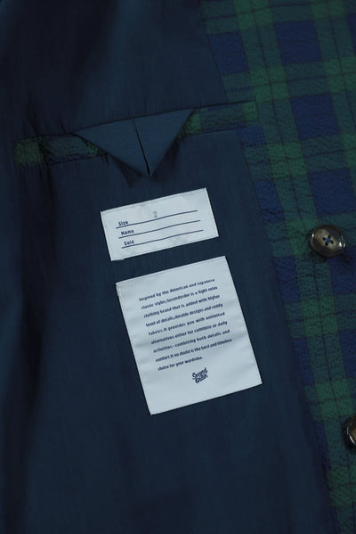 Navy shirt with brand label and tag on a textured gray background