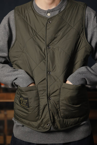 Dark green reversible vest with quilted design and jacquard knit detail.