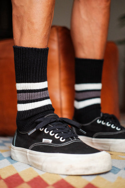 black sporty crew socks styled with Vans sneakers