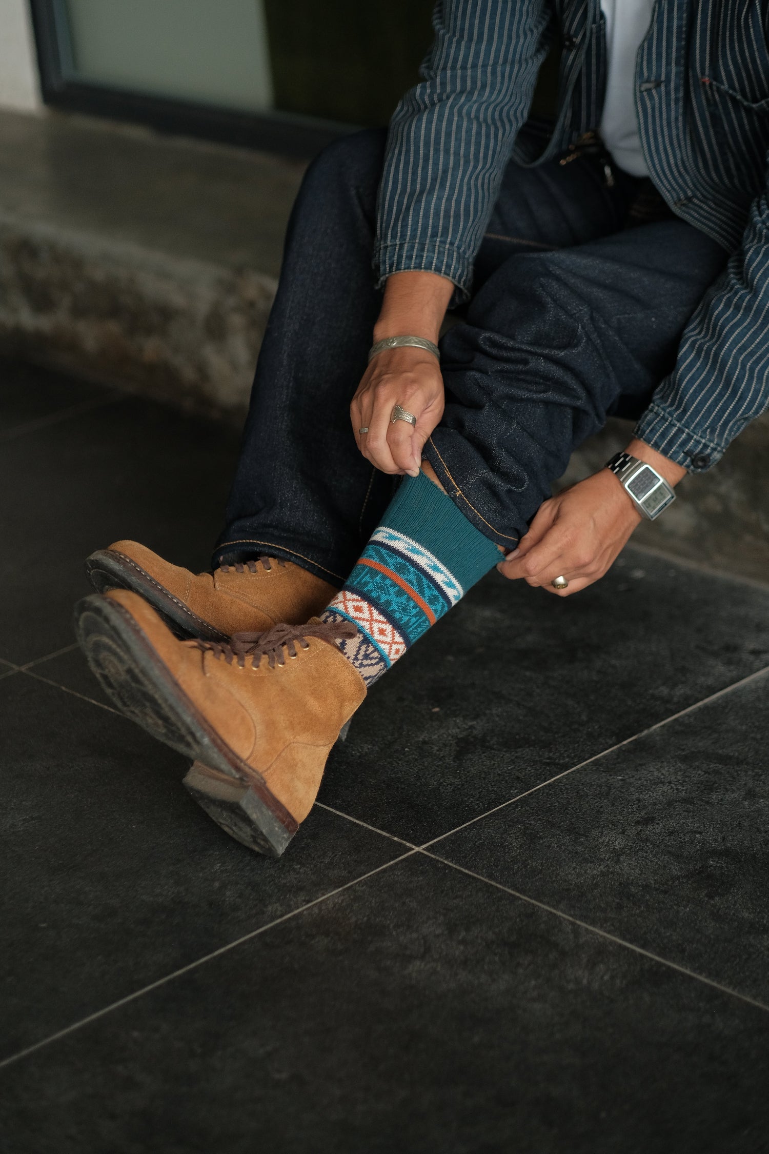 Boi blue and orange thick tribal crew socks worn in moody dark setting – ComfySocks
