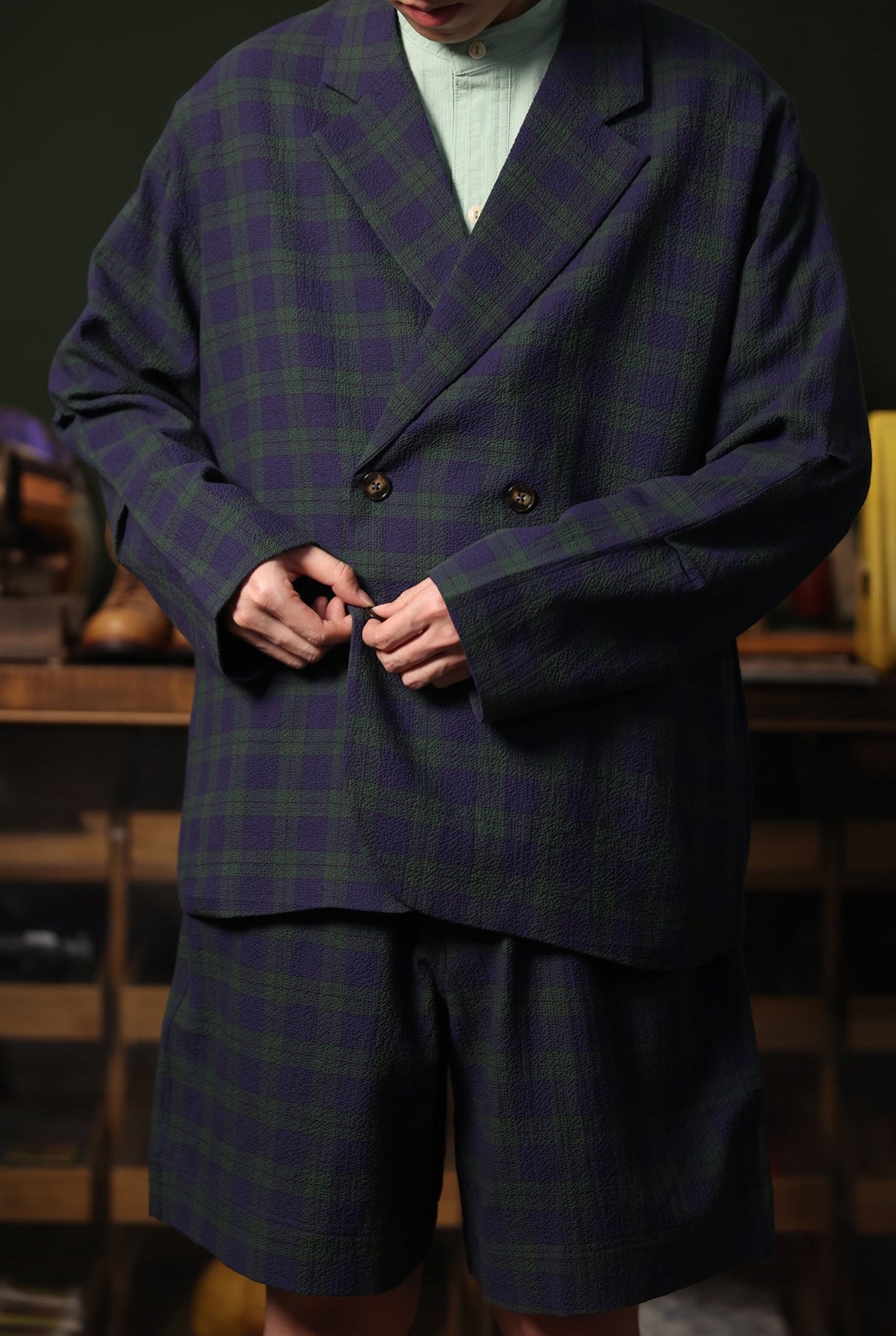 Person wearing a plaid suit with a blurred background
