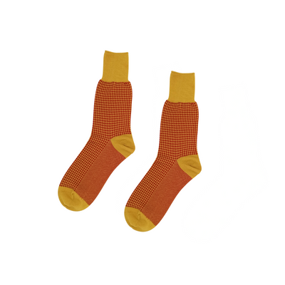 Thin retro socks with mustard cuff and rust red body, crew length.