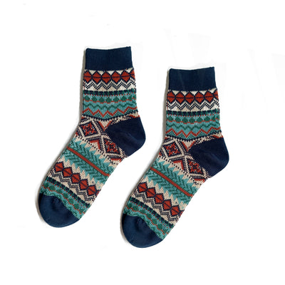 Thin blue ankle socks with tribal-inspired design on white background.