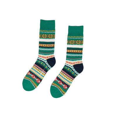 Colorful Nordic patterned green socks on white background
