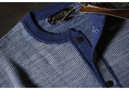 Close-up of indigo waffle knit henley showing textured cotton fabric and button placket