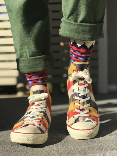 Tanami Tribal White socks styled with green Converse sneakers, funky streetwear look.
